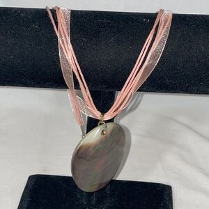 Ribbon Necklace with a large shell emblem